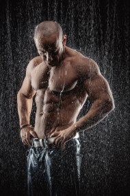 very muscular handsome athletic man in the rain